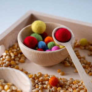 Schüssel mit Filzkugeln und Löffel